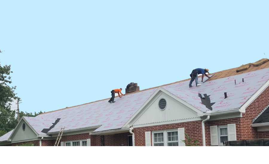 Summit 60 pink underlayment being applied to roof