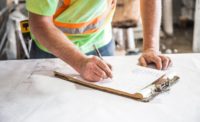construction worker writing on table top