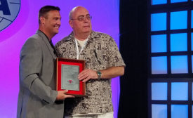 SMACNA President Joseph Lansdell (left) gives the Contractor of the Year Award to Milt Goodman.